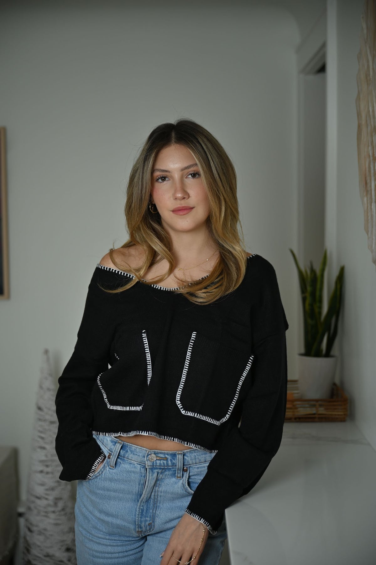 Black pullover sweater with European-inspired knit pattern and snug fit